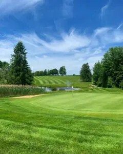 A golf course against a blue sky