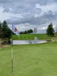 The cup and flag in the golf course